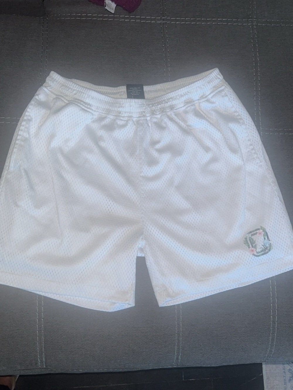 Men's White Athletic Mesh Shorts with Subtle Crest